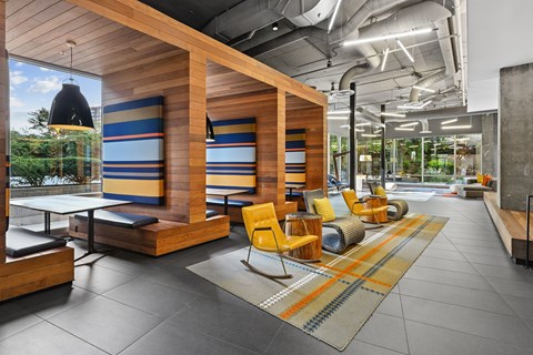 A modern office space with wooden furniture and a glass wall.