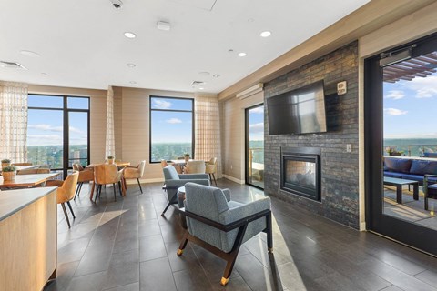 a living room with a fireplace and a table and chairs