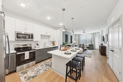 A modern kitchen with a large island and stainless steel appliances.
