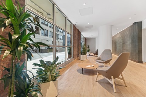 A modern lobby with a large window and a wooden floor.