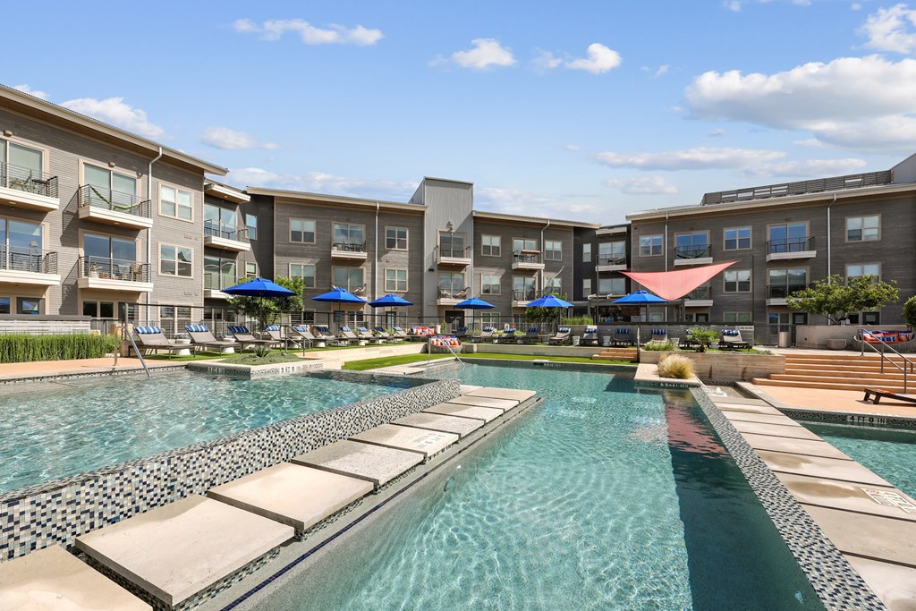 A swimming pool surrounded by apartment buildings.