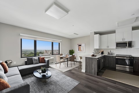 A modern living room with a grey sofa and a coffee table.