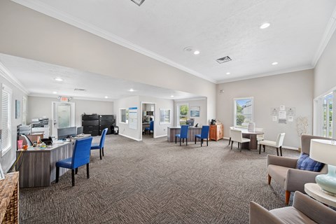 A spacious waiting room with chairs and a reception desk.