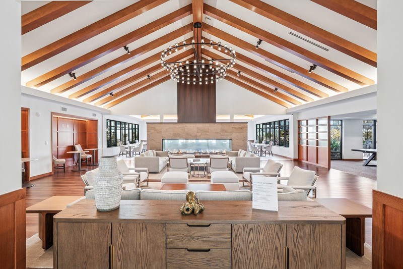 A large room with a wooden ceiling and furniture.