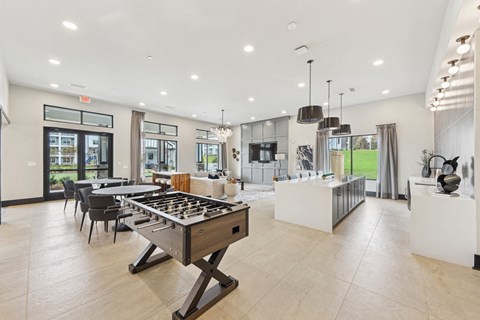 A modern kitchen with a large island and a dining table.