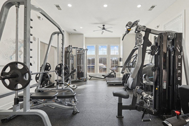 A well-equipped gym with a variety of machines and weights.