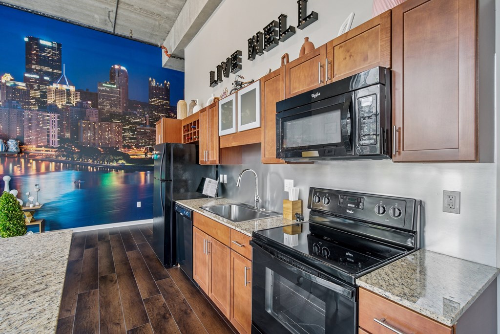 A kitchen with wooden cabinets and a cityscape mural on the wall.
