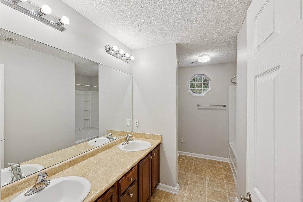 A bathroom with a vanity and a mirror.