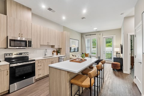 A modern kitchen with wooden cabinets and stainless steel appliances.
