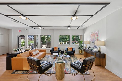 A living room with a large orange couch and a coffee table in the center.
