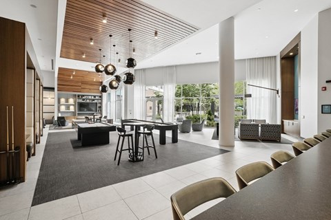 A modern dining room with a long table and chairs.