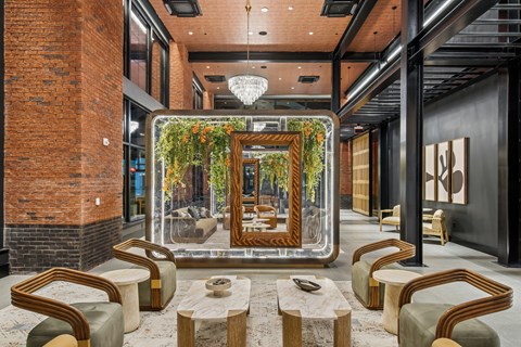 A modern living room with a large mirror and a chandelier.