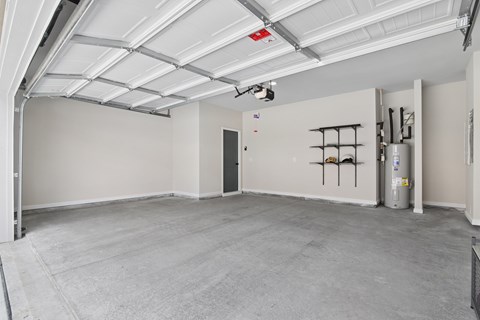 A spacious garage with a concrete floor and white walls.