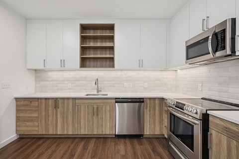 A kitchen with wooden cabinets and stainless steel appliances.