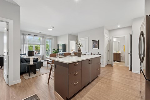 A modern kitchen with brown cabinets and a white countertop.