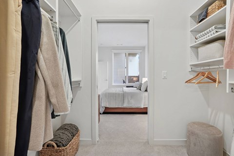 A hallway with a bedroom at the end.