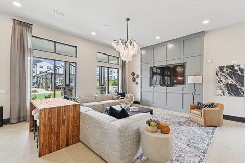 A modern living room with a large sectional sofa and a wooden coffee table.