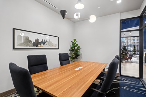 A conference room with a long table and chairs.
