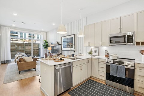 A modern kitchen with a dining table and chairs.