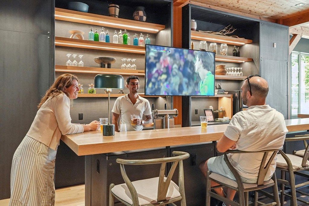 a group of people sitting at a bar