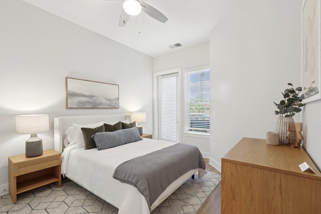 a bedroom with a large bed and a window