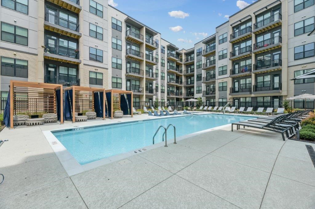 a swimming pool in front of an apartment building