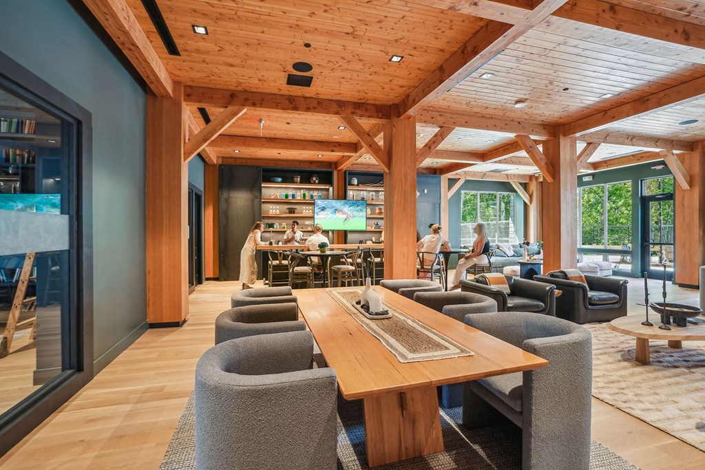 the lobby of a hotel with tables and chairs and a bar