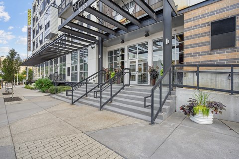 A building with a glass door and a metal railing.