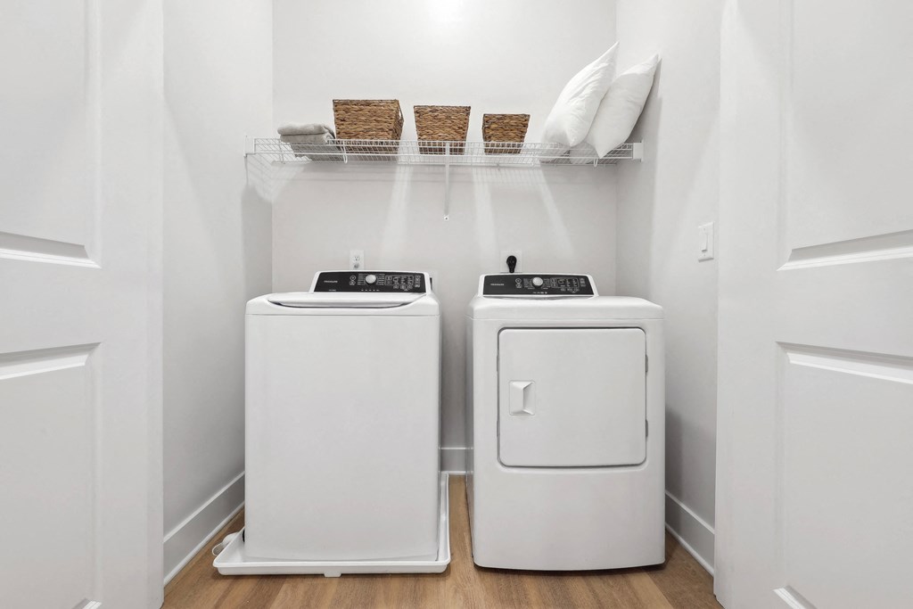 a laundry room with two washes and a dryer
