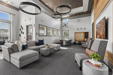 A modern living room with grey sofas and a wooden accent wall.