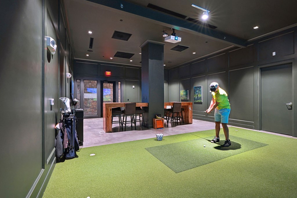 a man playing a game of golf on a putting green