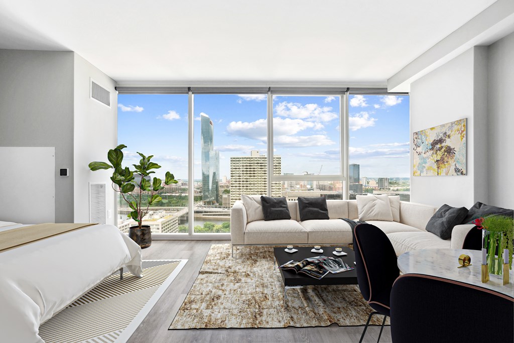 A modern living room with a view of the cityscape outside the window.