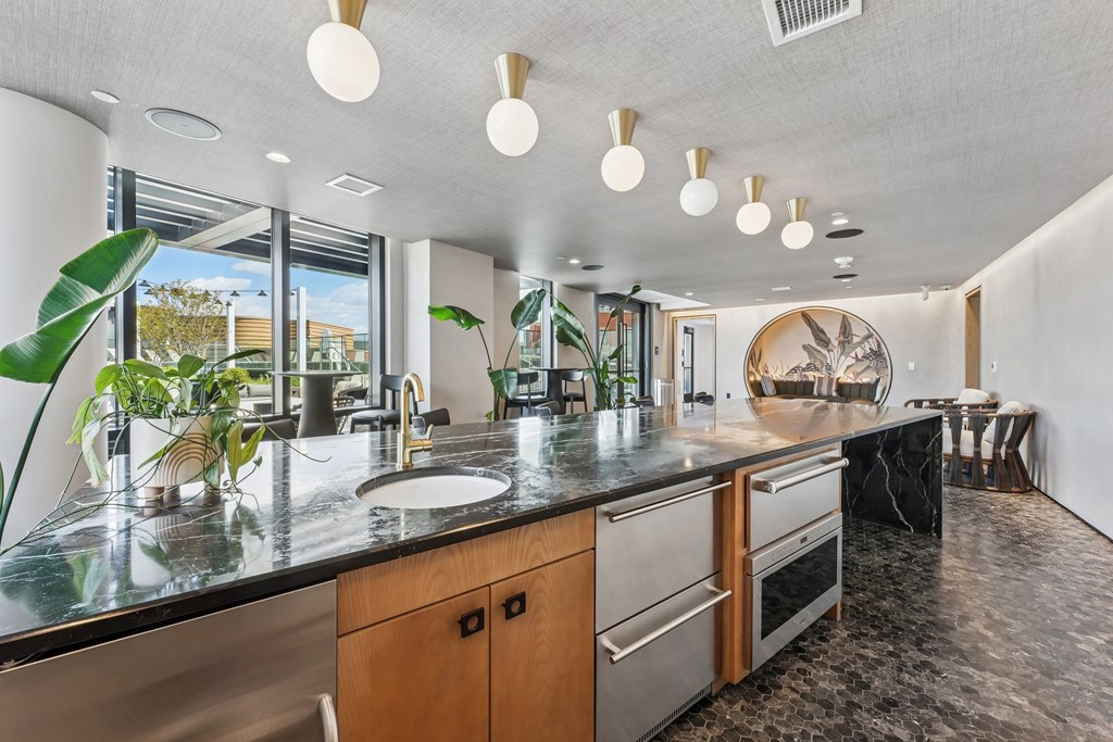 A modern kitchen with a large island and stainless steel appliances.