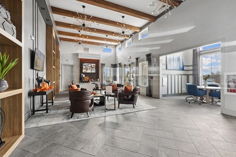 A modern living room with a wooden ceiling and grey tiled floor.