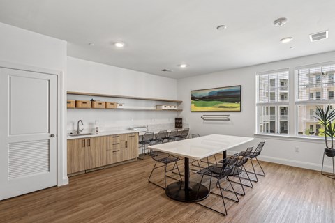 a dining room with a table and chairs and a kitchen
