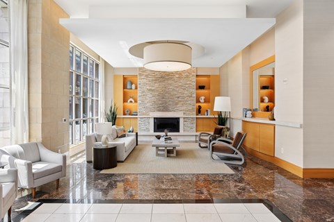 A living room with a fireplace and a large rug.