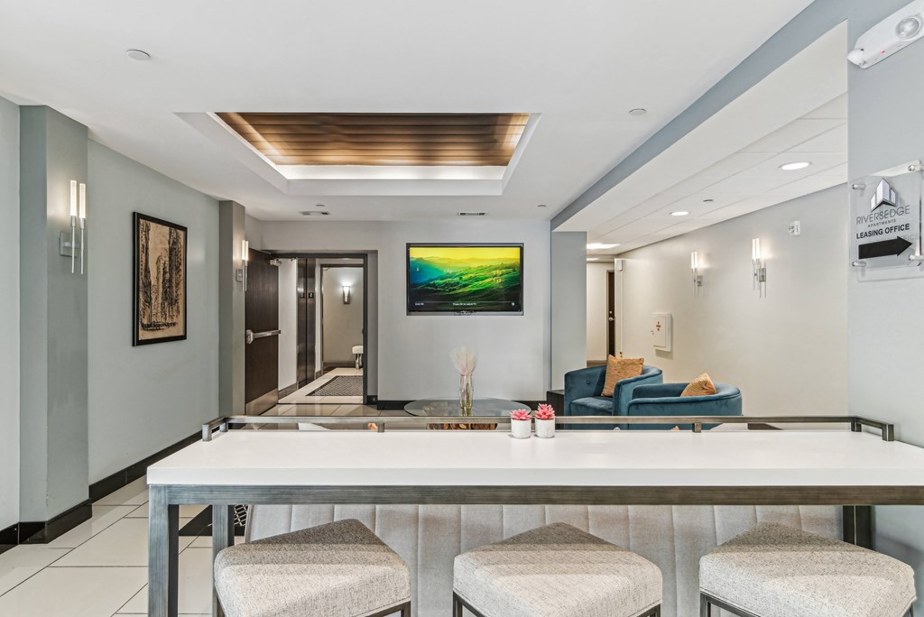a bar with four stools in a living room with a couch and a television