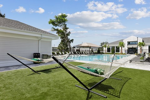 A soccer goal stands in the middle of a grassy yard.