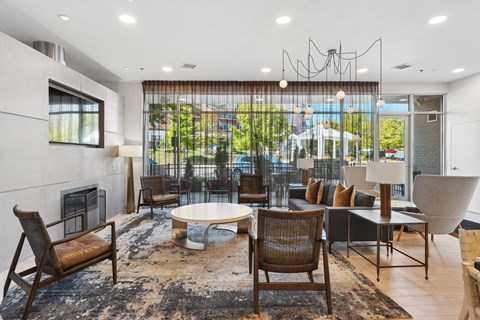 A modern living room with a large window and a fireplace.