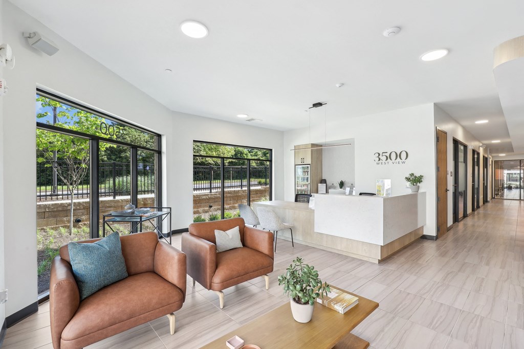 a large lobby with chairs and a reception desk