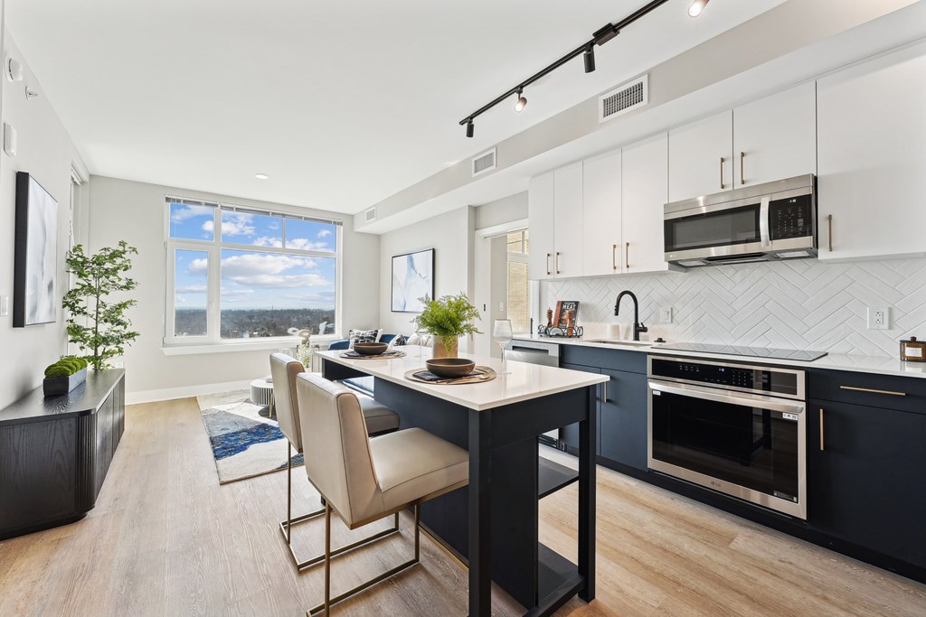 A modern kitchen with a dining table and chairs.