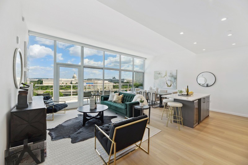 A modern living room with a view of the cityscape outside the large windows.