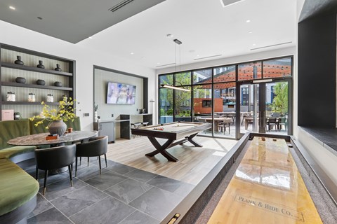 A modern dining room with a long table and chairs.