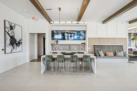 A modern dining room with a bar and a television mounted on the wall.