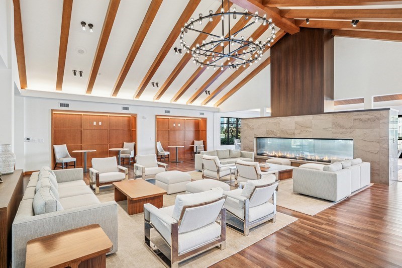 A spacious living room with a fireplace and a variety of seating options.