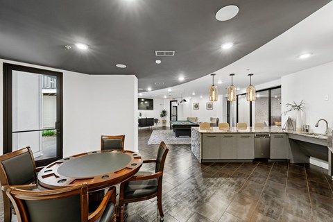 A modern kitchen with a dining table and chairs.