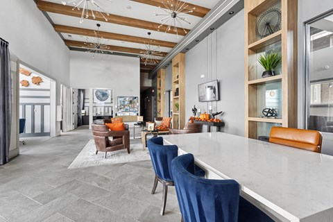 A modern dining room with a large table and chairs.