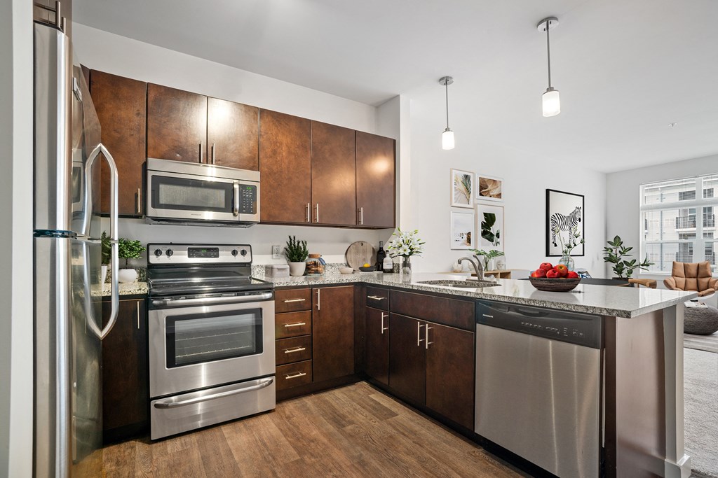 a kitchen with dark wood cabinets and stainless steel appliances