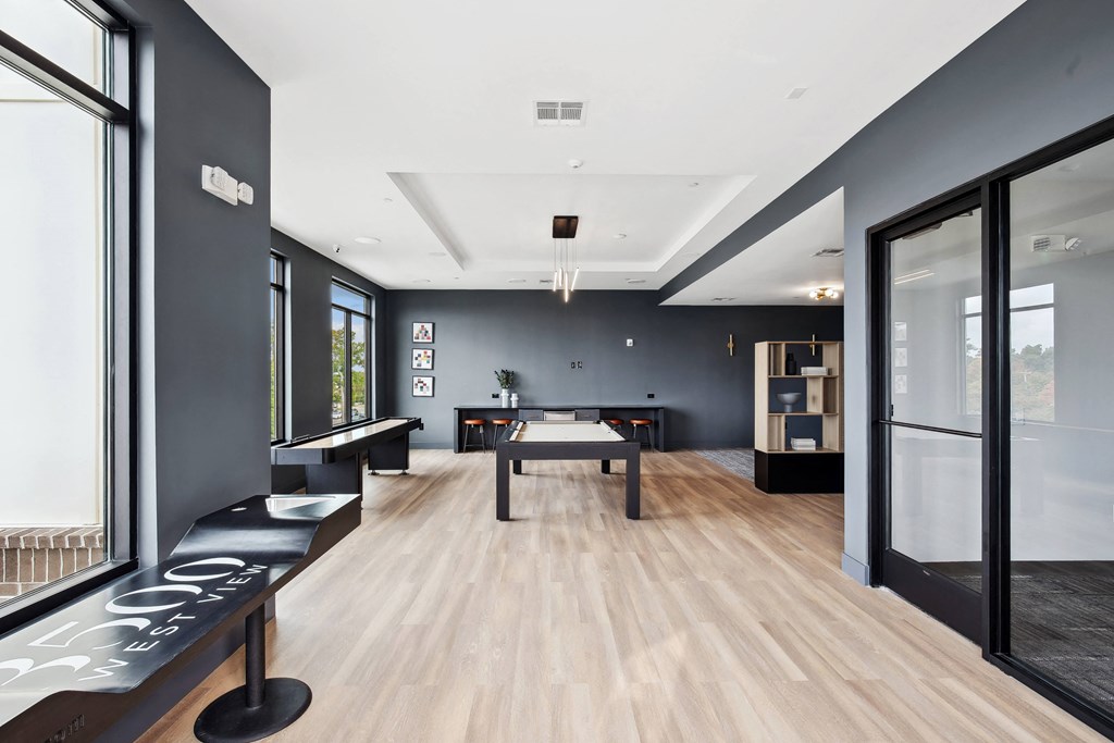 a game room with a ping pong table and a large window