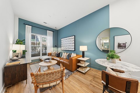 A living room with a brown chair and a white table.